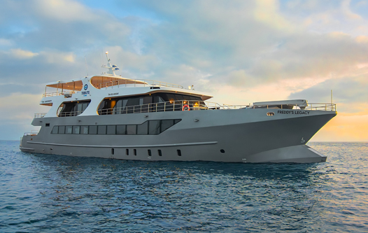 Galapagos cruise ship sailing at sunset