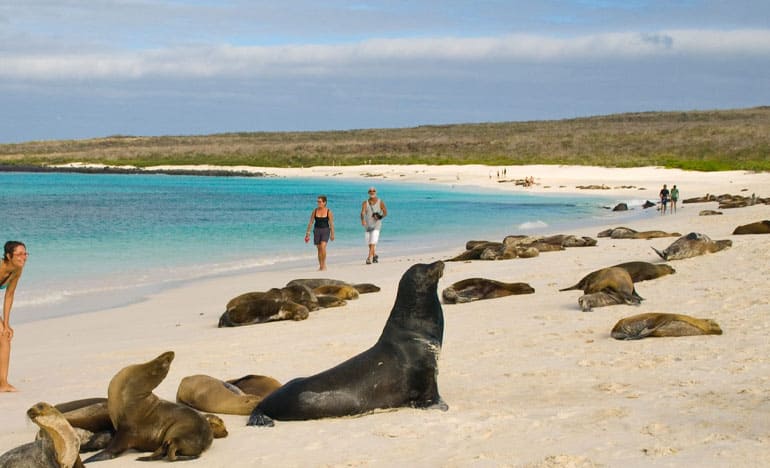 Two tourists in Bahia Sardina enjoying the trip on the 360  tour, San Cristobal - Galapagos Islands